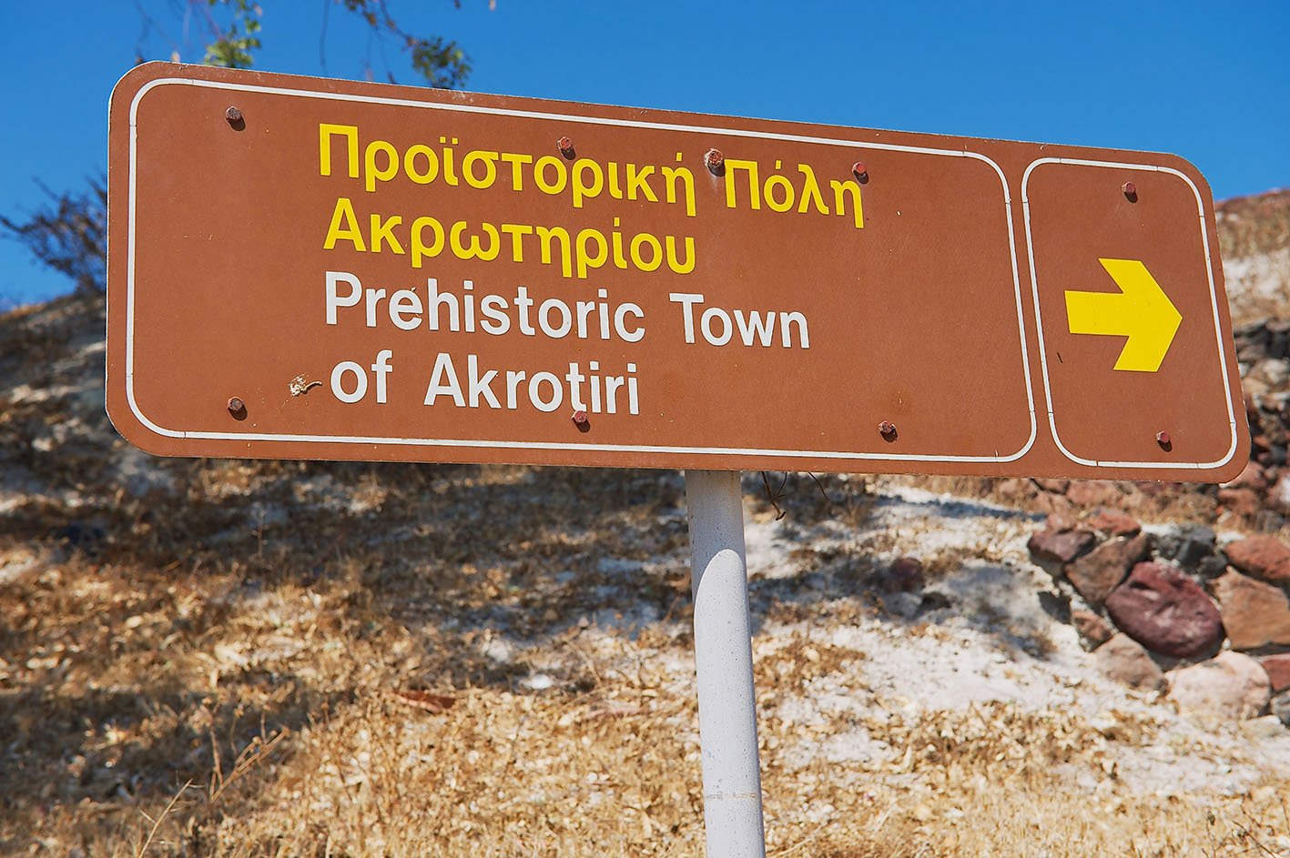 AKROTIRI, GREECE - AUGUST 01, 2012: Exterior of the sign pointing to the Akrotiri archaeological site in Akrotiri, Greece.